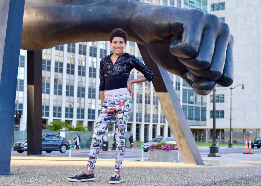 AJ wearing Detroit Has Legs skinnytees leggings in front of the Monument to Joe Louis, Hart Plaza Detroit