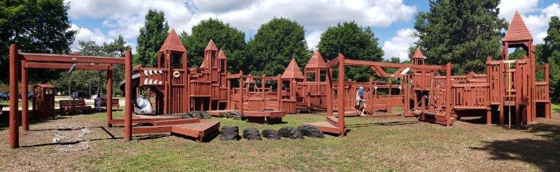 castle-themed wooden playground at Bay Court Park in Independence Township