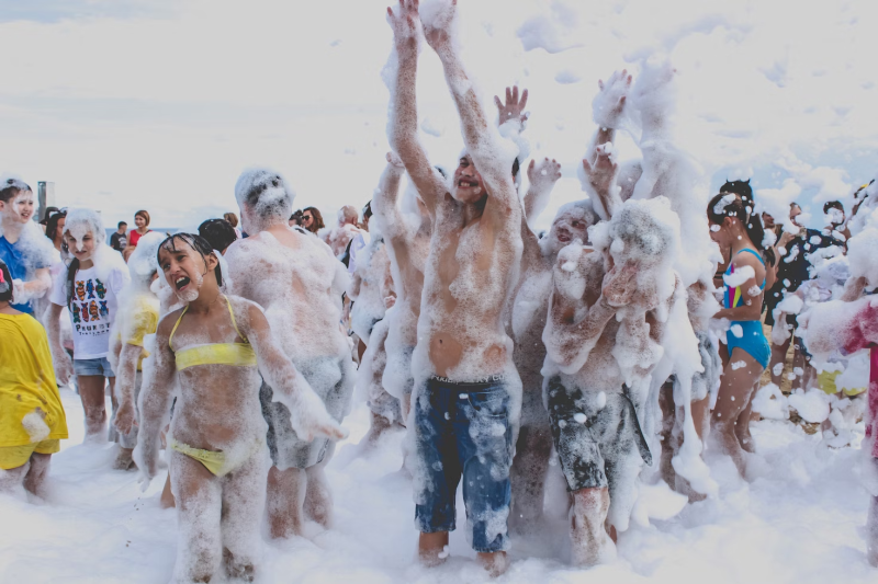 children of all ages at a foam party